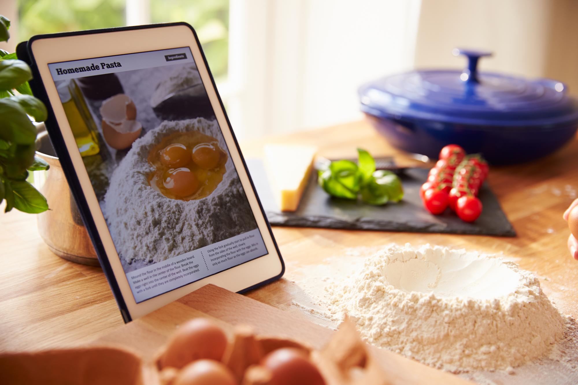Stacked recipe cards and a tablet showing lesson content